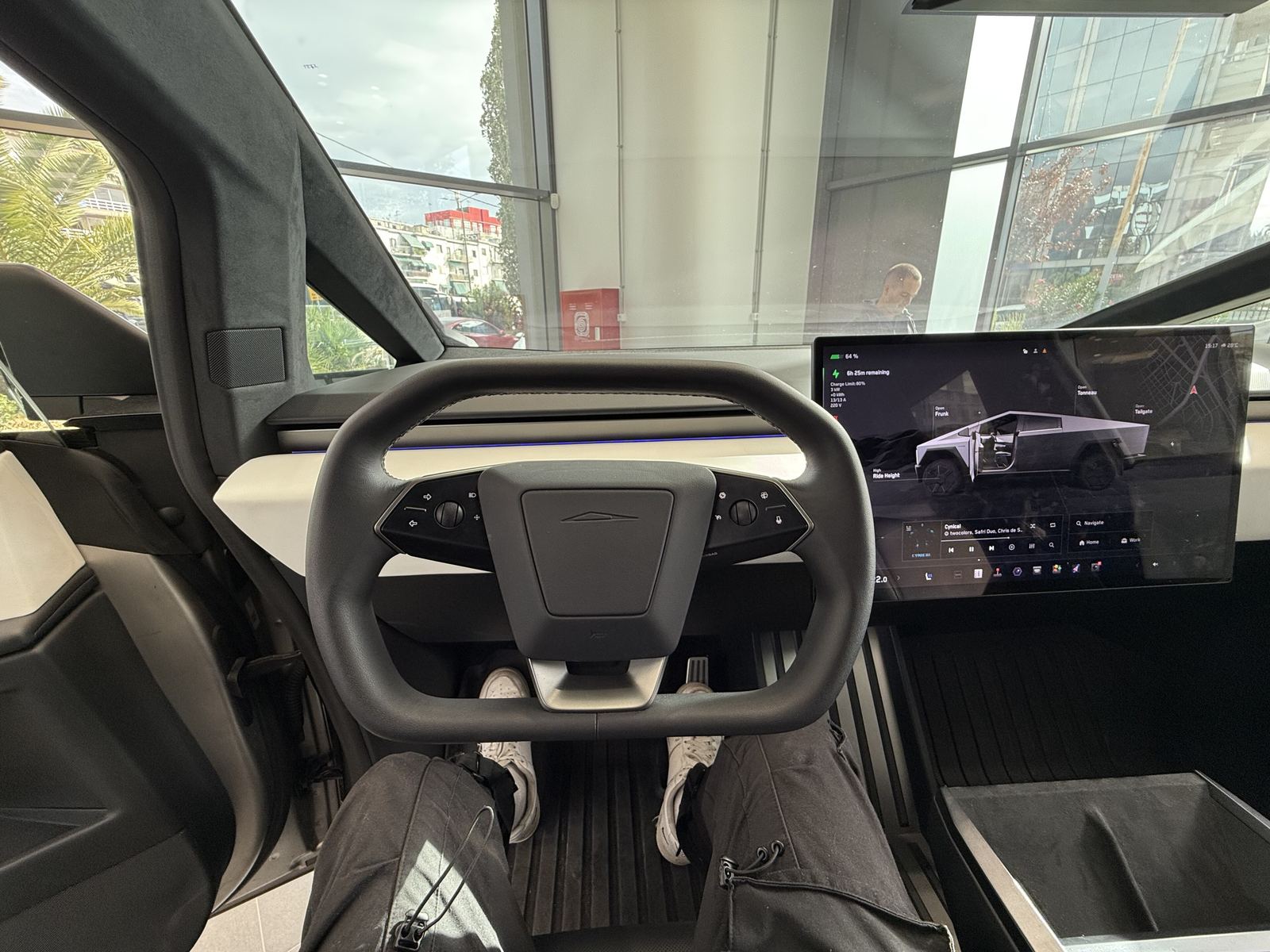 Cybertruck cabin with the yoke-style steering wheel and center touchscreen